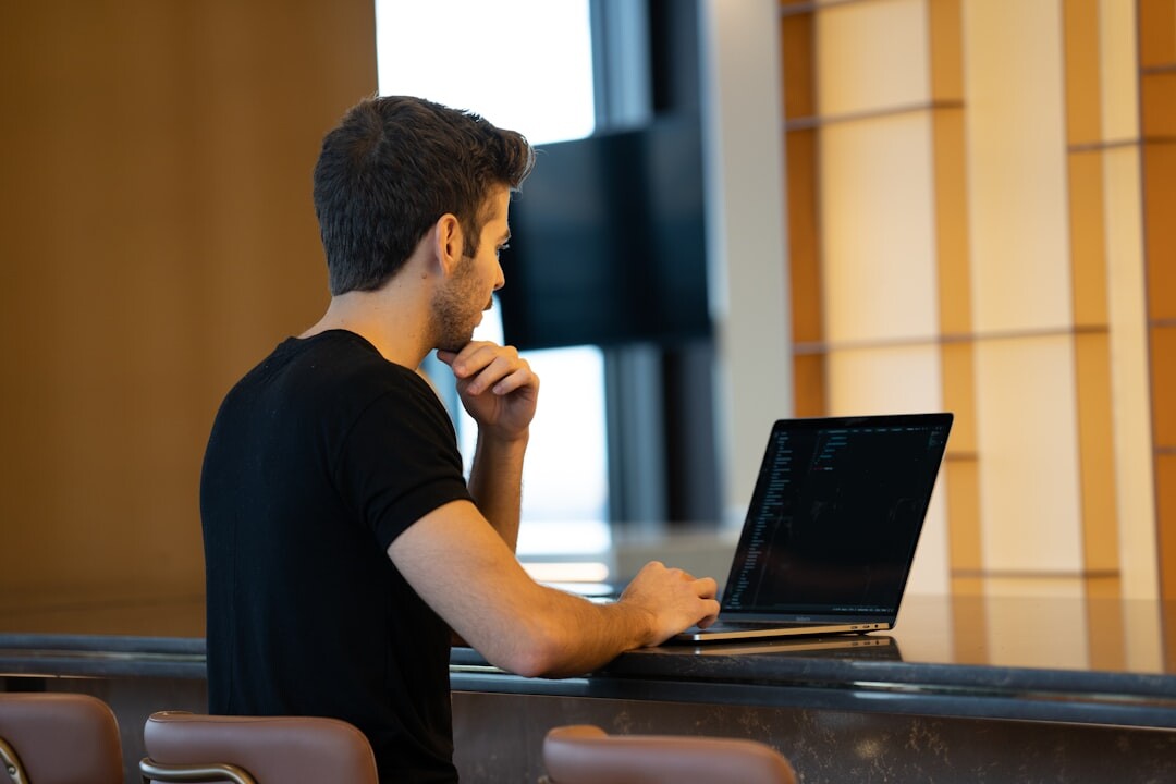Young man learning web development on a laptop